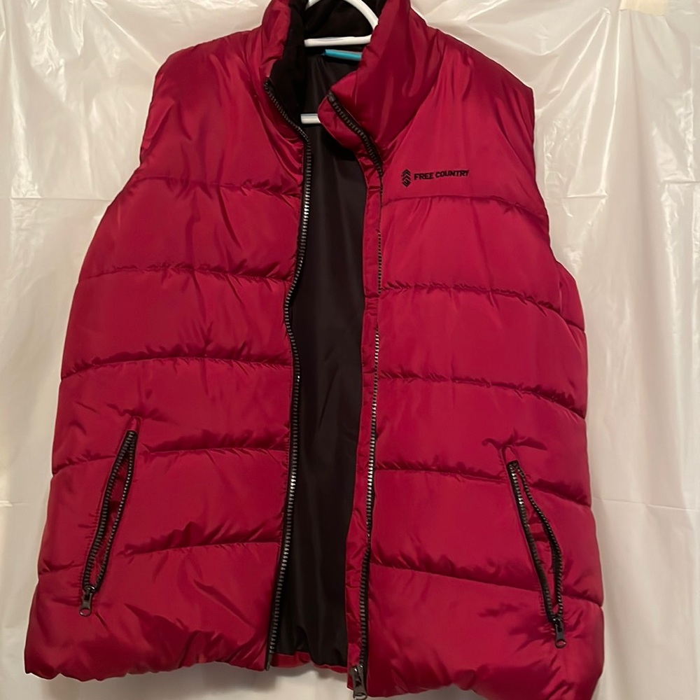 100% polyester … puffer vest.  More like burgundy red.